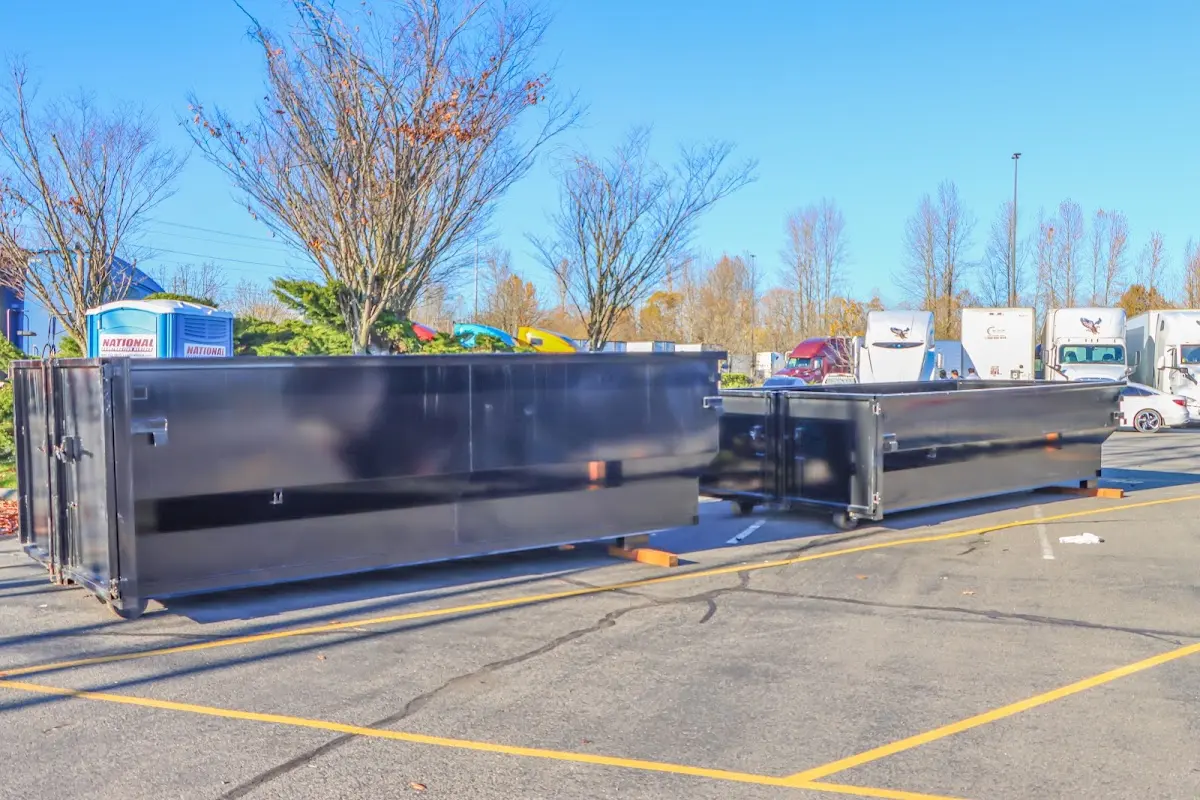 Professional dumpster rental service with roll-off container on residential driveway in West Jordan